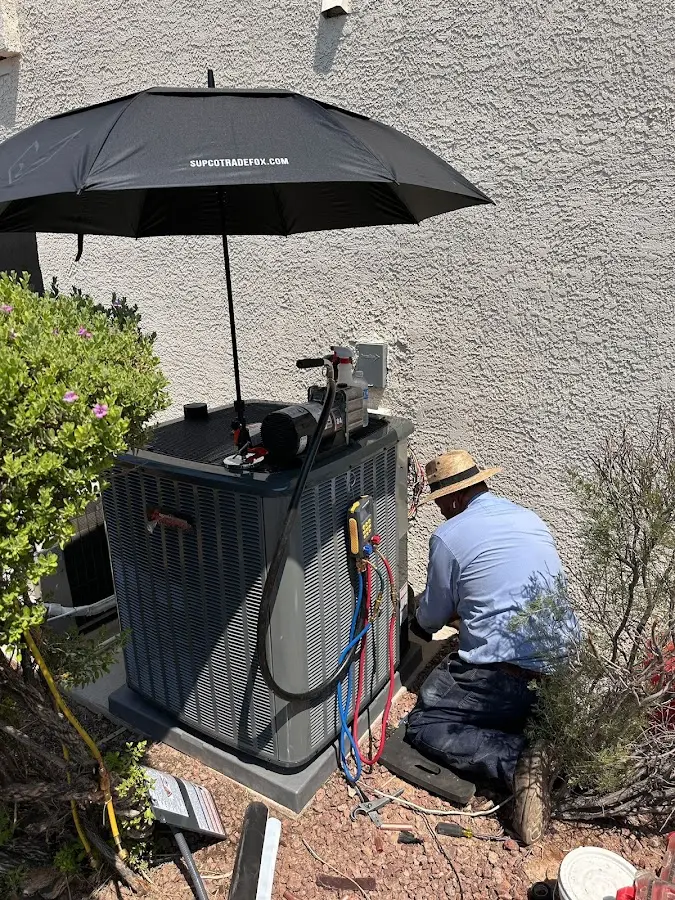 HVAC technician performing outdoor AC maintenance in Erie